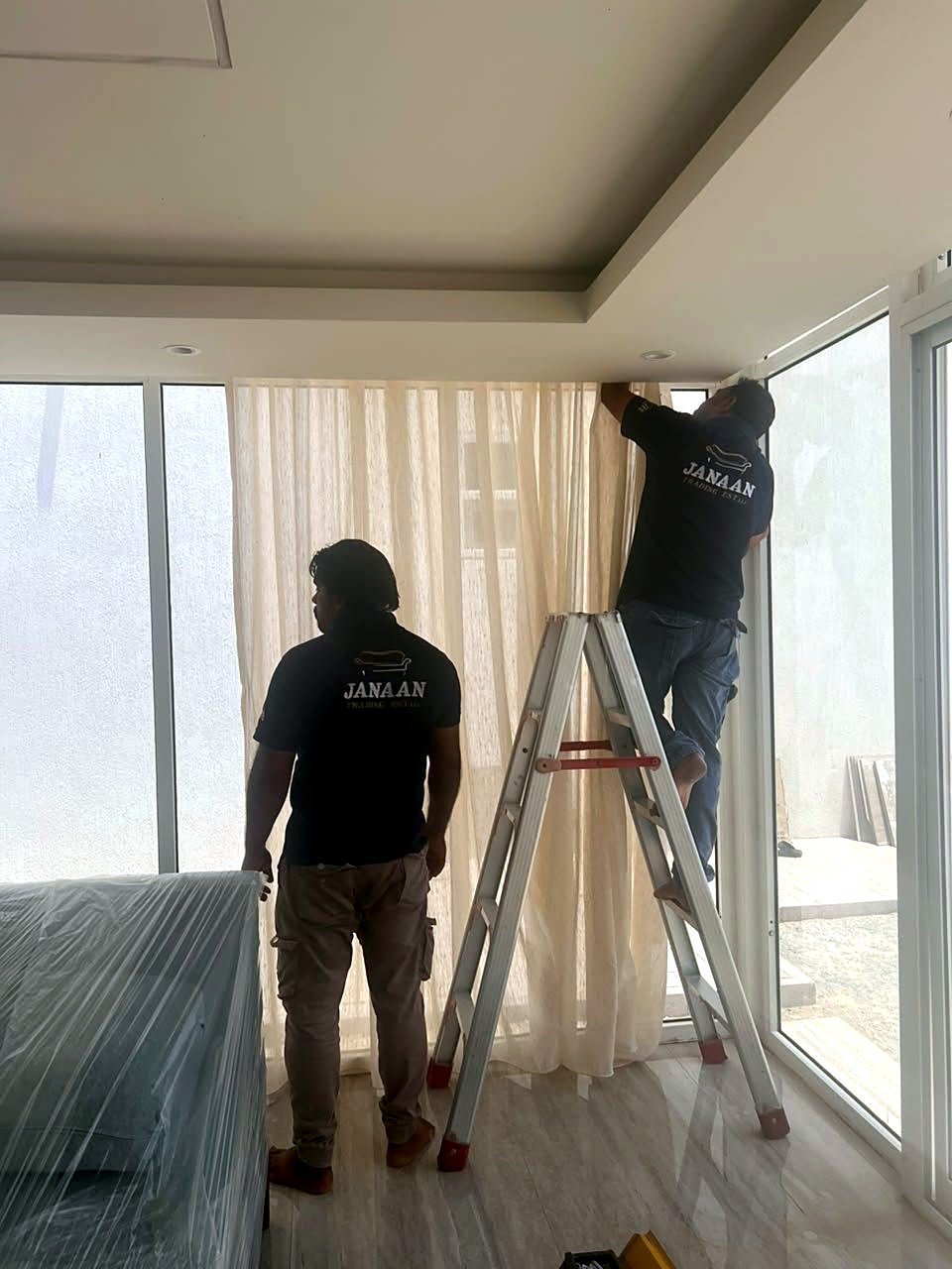 Janaan crew on site fitting curtains